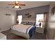 Comfortable bedroom with a ceiling fan, bedside tables, and soft, natural lighting at 954 Lockbreeze Dr, Davenport, FL 33897