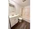 A bathroom featuring a bathtub, toilet, vanity, and hard wood floors at 101 Scottsdale Sq # 101, Winter Park, FL 32792