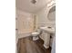 A bathroom featuring a bathtub, toilet, sink, and hard wood floors at 101 Scottsdale Sq # 101, Winter Park, FL 32792