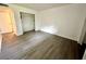 The bedroom has hard wood floors, a closet with sliding doors, a window, and white walls at 101 Scottsdale Sq # 101, Winter Park, FL 32792