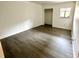 A bedroom with hard wood floors, a closet, a window, and white walls at 101 Scottsdale Sq # 101, Winter Park, FL 32792