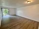 The living room has hard wood floors and a glass sliding door that leads to the outside at 101 Scottsdale Sq # 101, Winter Park, FL 32792