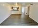 An open-concept living room and kitchen featuring a breakfast bar and hard wood floors at 101 Scottsdale Sq # 101, Winter Park, FL 32792