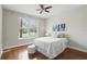 Comfortable bedroom with hardwood floors, natural light, and a ceiling fan at 11866 Barletta Dr, Orlando, FL 32827