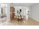 Cozy dining area with a modern table, built-in wood cabinets, and access to the entryway at 11866 Barletta Dr, Orlando, FL 32827