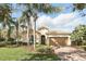 Charming single-story home with a tile roof, mature landscaping, and a brick driveway at 11866 Barletta Dr, Orlando, FL 32827