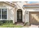 Elegant front entrance features a decorative glass door and a well-manicured walkway at 11866 Barletta Dr, Orlando, FL 32827