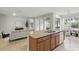 Kitchen island with a sink, granite countertops, and seamless flow into the living room at 11866 Barletta Dr, Orlando, FL 32827