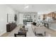 Bright living room featuring a large window, neutral décor, and seamless access to the outdoor patio at 11866 Barletta Dr, Orlando, FL 32827