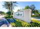 Community entrance sign with colorful flowers and manicured landscaping at 11866 Barletta Dr, Orlando, FL 32827