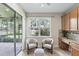 Cozy sitting area with sliders leading to the lanai, complete with built-in desk and cabinet at 11866 Barletta Dr, Orlando, FL 32827