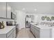 Bright kitchen with stainless steel appliances, gray cabinets, and a center island at 1503 Fountain View St, Ormond Beach, FL 32174