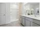 Bright bathroom featuring double sink vanity, a large mirror, and a walk-in shower at 1507 Fountain View St, Ormond Beach, FL 32174
