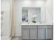Bright bathroom featuring double sink vanity, a large mirror, and a walk-in shower at 1507 Fountain View St, Ormond Beach, FL 32174