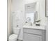 Well-lit bathroom featuring white vanity, gray cabinets, and a modern, framed mirror at 1507 Fountain View St, Ormond Beach, FL 32174