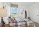 A cozy bedroom with a plaid comforter and an ample view from the window at 1507 Fountain View St, Ormond Beach, FL 32174