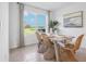 Well-lit dining room with wicker chairs and a view of the landscaped backyard at 1507 Fountain View St, Ormond Beach, FL 32174