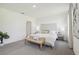 Bright bedroom featuring neutral color palette, carpeted floors, a padded headboard, and stylish furnishings at 1507 Fountain View St, Ormond Beach, FL 32174