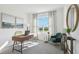 Bright office featuring a large window, sleek desk, a comfortable chair, and a round decorative mirror at 1507 Fountain View St, Ormond Beach, FL 32174