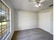 Well-lit bedroom featuring carpeted floors, closet, and a large window at 15525 Seymour Ln, Groveland, FL 34736