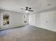 Spacious bedroom featuring neutral carpet, two windows for natural light, and double door closets at 15525 Seymour Ln, Groveland, FL 34736