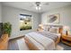 Bright bedroom with large window, contemporary decor, and a ceiling fan at 15525 Seymour Ln, Groveland, FL 34736
