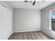 Bedroom with light-colored walls, carpet, ceiling fan, a closet, and a window at 15525 Seymour Ln, Groveland, FL 34736