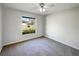 Bedroom featuring neutral carpet and a large window offering lots of natural light at 15525 Seymour Ln, Groveland, FL 34736