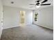 Bedroom with a view of the en suite bathroom through an open doorway at 15525 Seymour Ln, Groveland, FL 34736