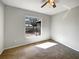 Bedroom with neutral carpet and a large window offering bright, natural light at 15525 Seymour Ln, Groveland, FL 34736