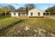 Charming single-story home featuring a well-maintained lawn and a screened-in porch at 15525 Seymour Ln, Groveland, FL 34736