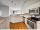 Modern kitchen featuring stainless steel appliances, white cabinets, and a breakfast bar at 15525 Seymour Ln, Groveland, FL 34736