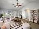 Inviting living room with vaulted ceiling, neutral decor and natural light from large windows at 15525 Seymour Ln, Groveland, FL 34736