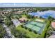 An aerial view showcasing community amenities including tennis courts, volleyball court, a basketball court and lake access at 1613 Glenwick Dr, Windermere, FL 34786