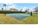 Outdoor basketball court surrounded by lush landscaping overlooking a lake at 1613 Glenwick Dr, Windermere, FL 34786