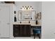 Stylish bathroom with vanity, quartz countertop, dark cabinets, and a blue stool at the makeup station at 1613 Glenwick Dr, Windermere, FL 34786