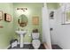 Charming bathroom with pedestal sink, beach-themed decor, and a shower at 1613 Glenwick Dr, Windermere, FL 34786