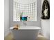 Bright bathroom features a soaking tub, stylish decor, and unique glass block window for natural light at 1613 Glenwick Dr, Windermere, FL 34786