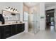 Modern bathroom with glass enclosed shower, dark wood cabinets, and a long white countertop with double sinks at 1613 Glenwick Dr, Windermere, FL 34786
