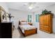 Cozy bedroom with carpet, white wainscotting, and a wooden wardrobe cabinet at 1613 Glenwick Dr, Windermere, FL 34786