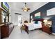 Spacious bedroom with a dark accent wall, wooden furniture, ceiling fan, and neutral carpet flooring at 1613 Glenwick Dr, Windermere, FL 34786