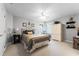Comfortable bedroom with neutral tones, ceiling fan and a well-lit seating area near the window at 1613 Glenwick Dr, Windermere, FL 34786