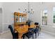 Dining room with wood table, chandelier, large window, and classic china cabinet at 1613 Glenwick Dr, Windermere, FL 34786