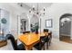 Bright dining room featuring a wooden table, chandelier, and elegant archway at 1613 Glenwick Dr, Windermere, FL 34786