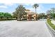 Community entrance with a guard house and beautiful landscaping at 1613 Glenwick Dr, Windermere, FL 34786