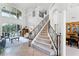 Grand foyer featuring high ceilings, large windows, tile flooring, and an elegant staircase at 1613 Glenwick Dr, Windermere, FL 34786