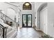 Spacious foyer featuring tile flooring, a staircase with iron railings, and a view of the double-door entryway at 1613 Glenwick Dr, Windermere, FL 34786