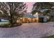 Rear view of a home highlighting the 3-car garage and brick driveway at 1613 Glenwick Dr, Windermere, FL 34786