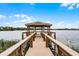 Picturesque view of a gazebo at the end of a wooden dock on the lake at 1613 Glenwick Dr, Windermere, FL 34786