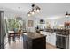 Spacious kitchen with stainless steel appliances, granite countertops, and open access to the dining and living areas at 1613 Glenwick Dr, Windermere, FL 34786